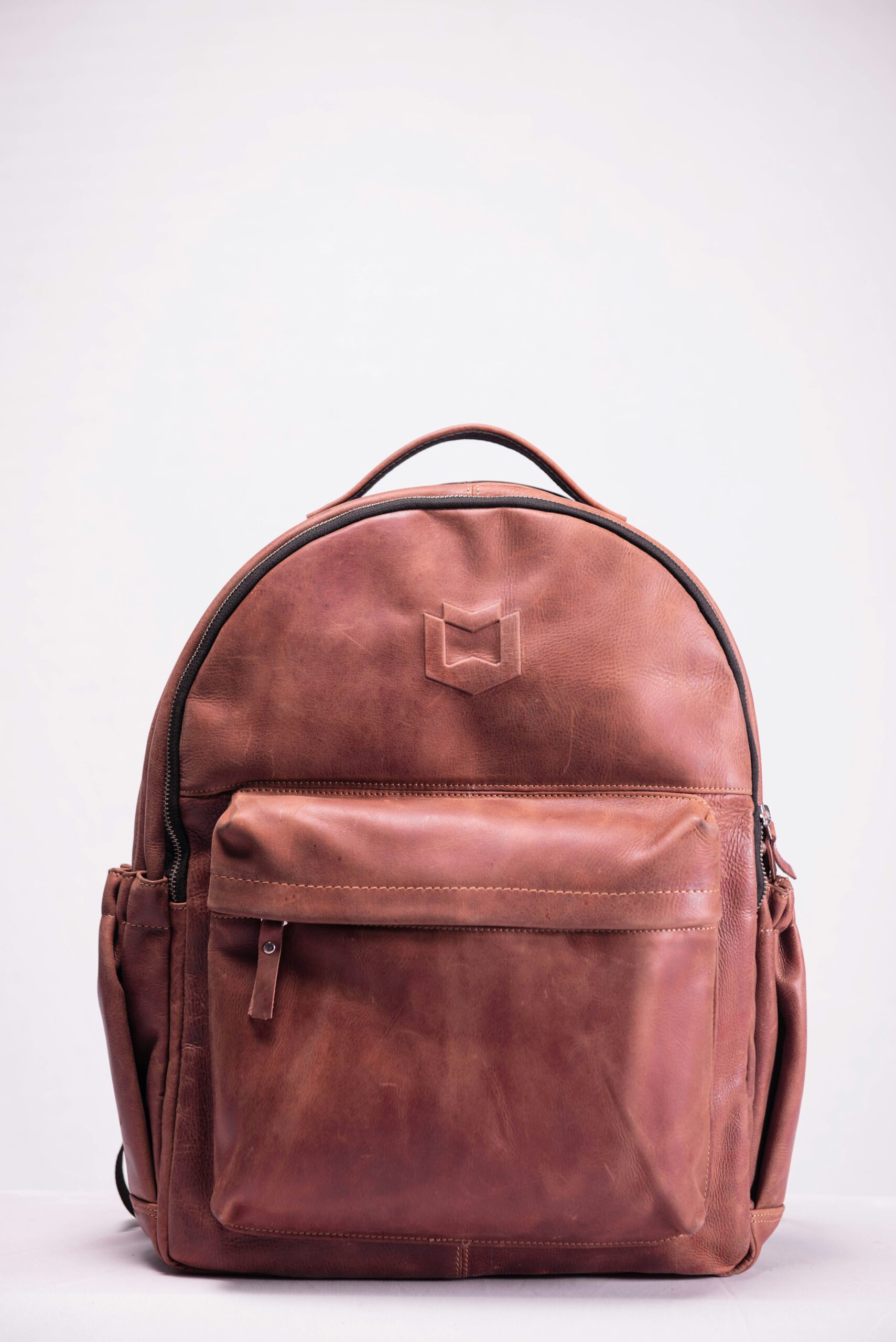 brown leather backpack on white background