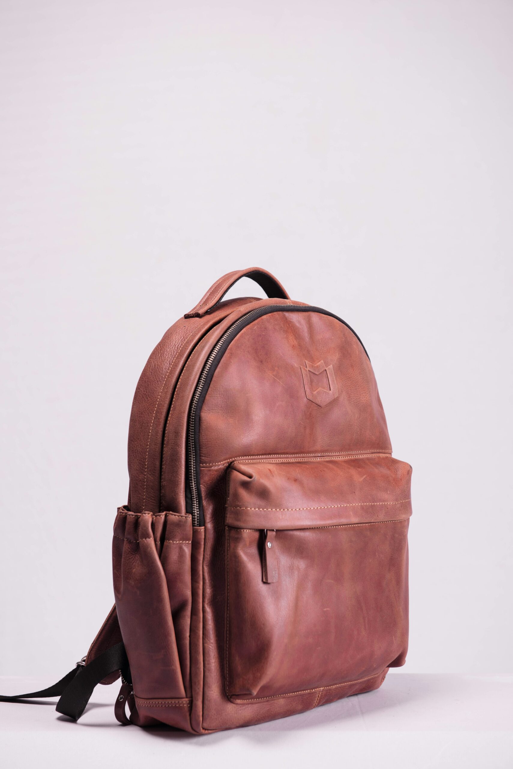 Sideview of brown leather backpack